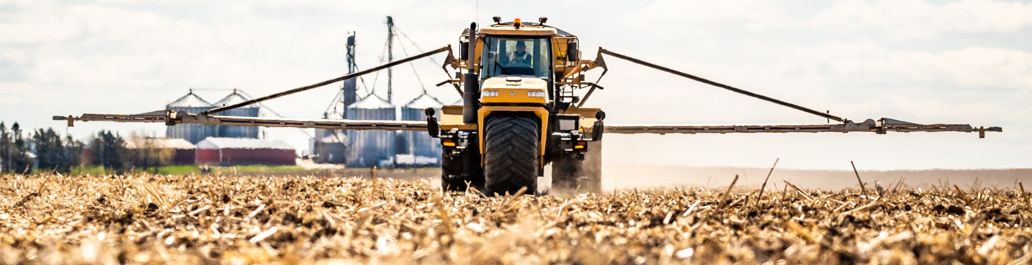 Crop sprayer driving through a field