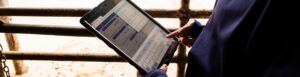Hands holding a tablet showing MyCHS software