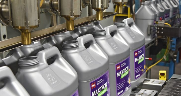 Cenex Maxtron product jugs sitting on a fill line