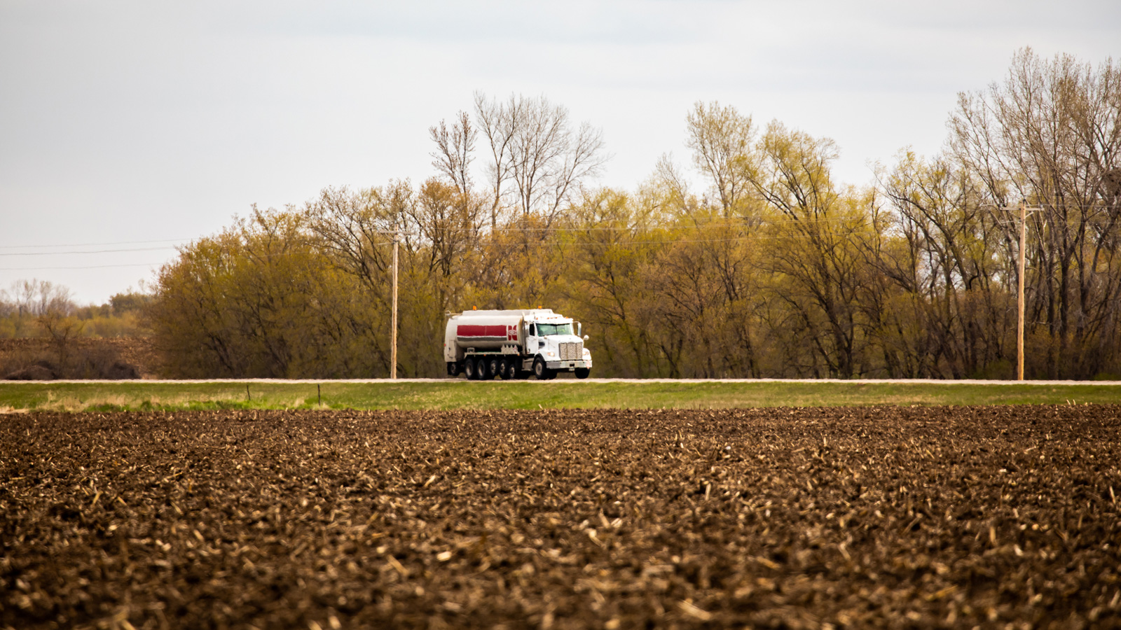 Small fuels truck driving down a country road